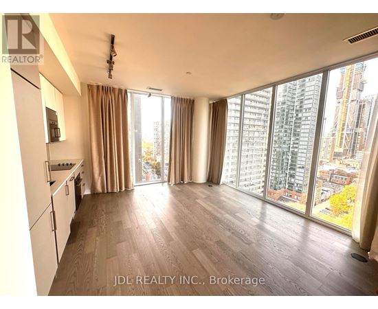 A spacious kitchen and living room with a view of the city.