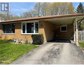 A house numbered 87 with a driveway leading to the front door.