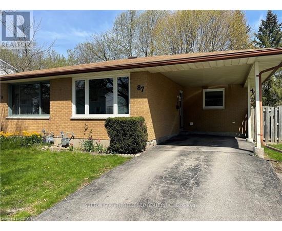 A house numbered 87 with a driveway leading to the front door.