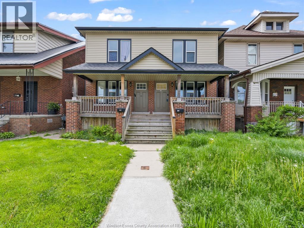 A house with a green lawn in front of it.