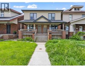 A house with a green lawn in front of it.