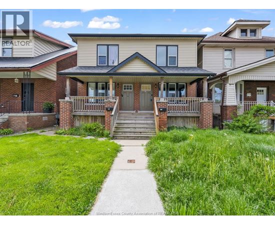 A house with a green lawn in front of it.