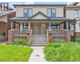 A house with a front porch and a green lawn.
