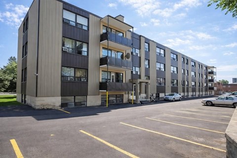 A large building with a parking lot in front of it.