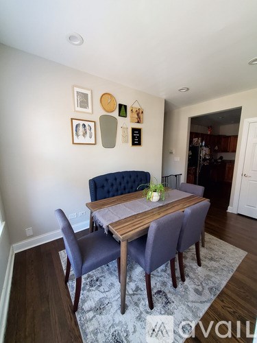 A dining room with a table and chairs.