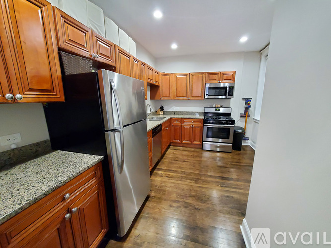 A kitchen with wooden cabinets and stainless steel appliances.