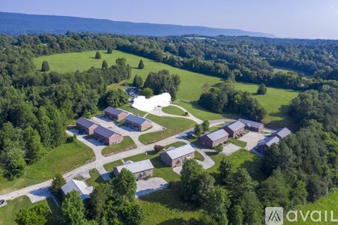 A bird's eye view of a farm with buildings and greenery.