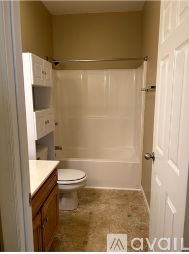 A bathroom with a toilet, a tub, and a sink.