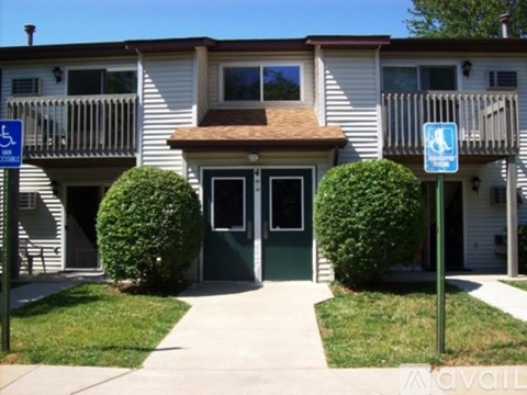 A building with a blue and white sign in front of it.