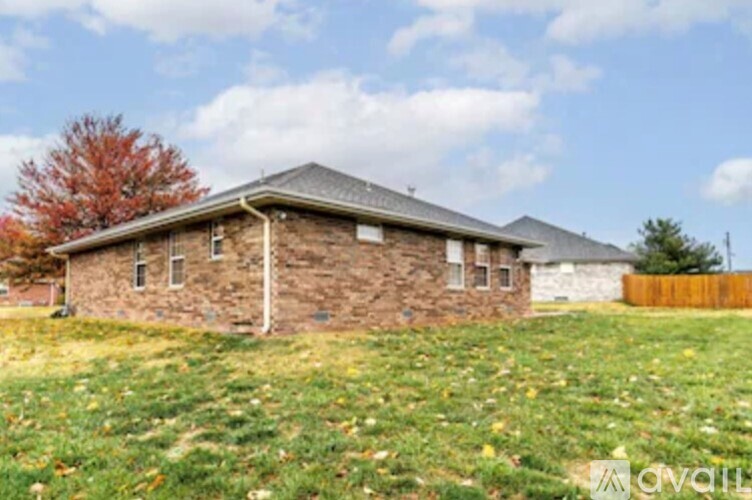 A house with a grassy lawn in front of it.