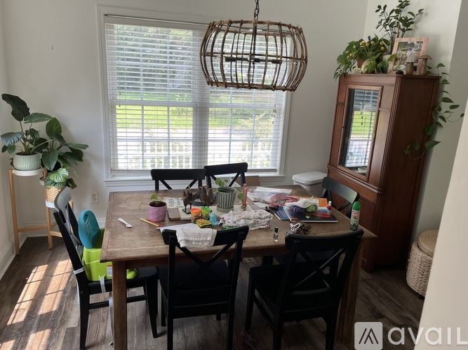A dining room with a wooden table and chairs.