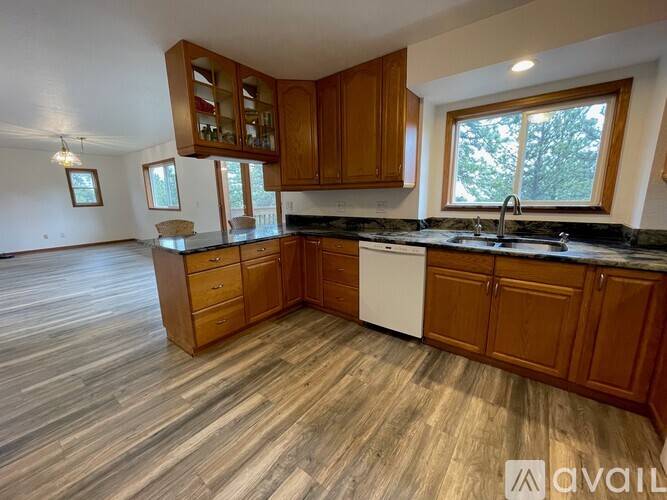 A kitchen with wooden cabinets and a black countertop.