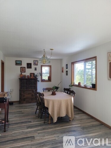 A dining room with a table set for four.