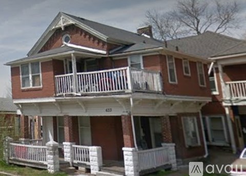 A two-story house with a balcony and a porch.