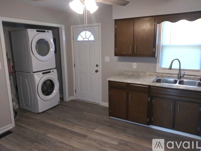 A laundry room with a washer and dryer stacked on top of each other.