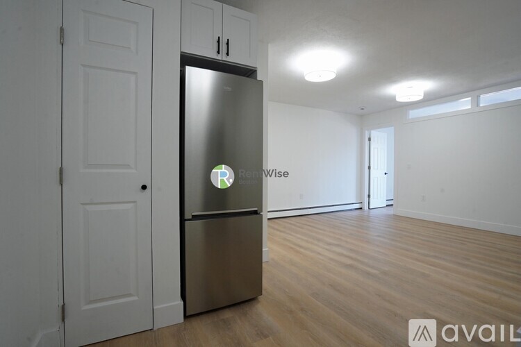 A Refrigerator is in the corner of a kitchen.