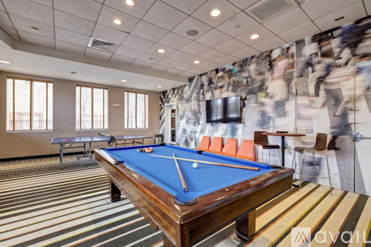 A pool table in a room with a striped carpet.