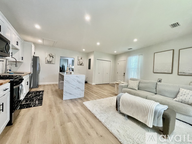 A room with a ceiling fan and a long table with a window.