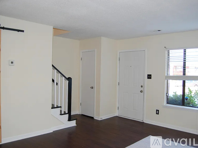A room with a staircase and two doors.