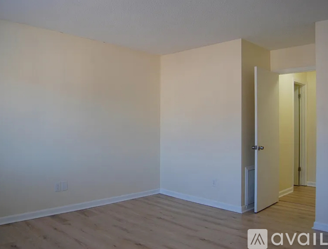 A room with a door and a wall socket.
