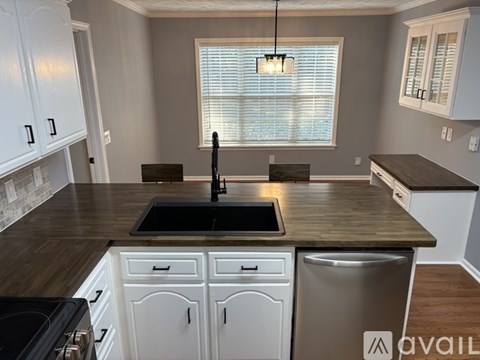 A kitchen with a sink and a window.