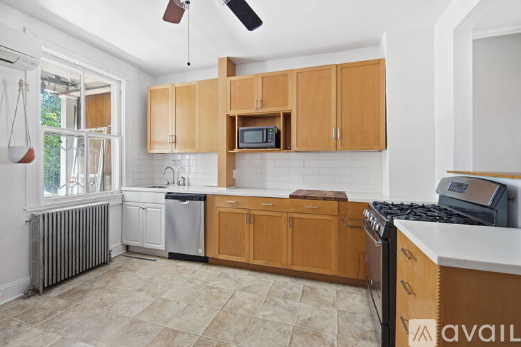 A kitchen with wooden cabinets and a white countertop.