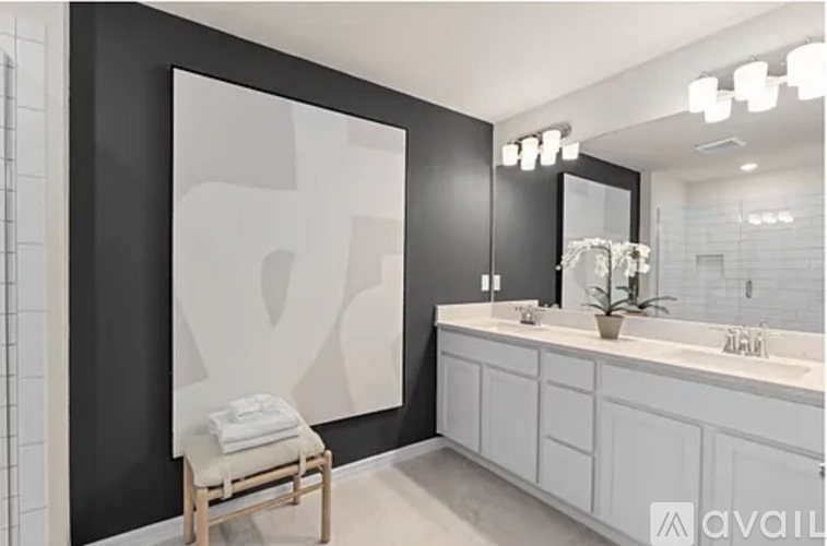 A bathroom with a white counter and a mirror above it.