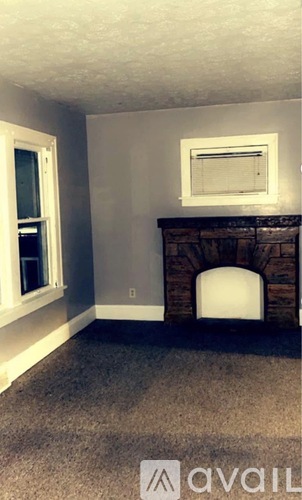 A room with a fireplace and a window.