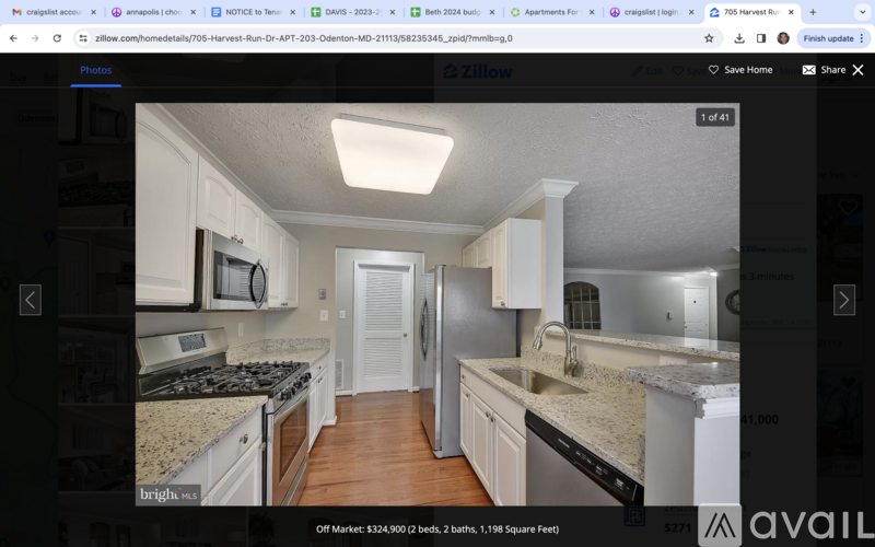 A kitchen with granite countertops and white cabinets is on the market for $271.
