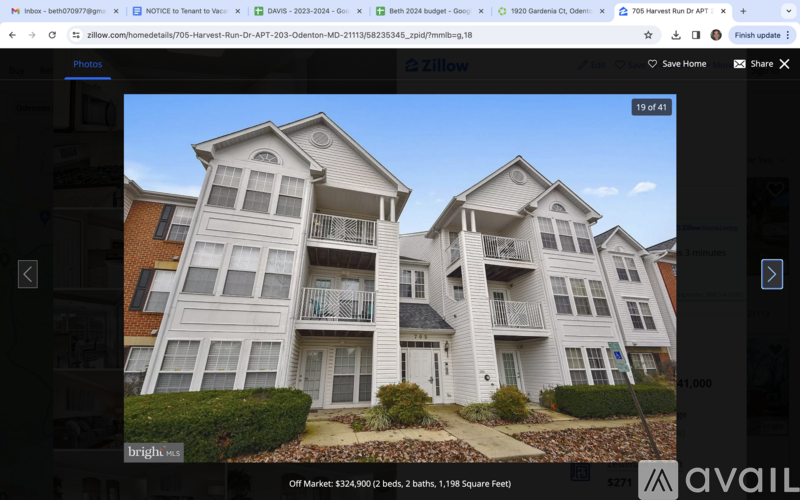 A two-story apartment building with a balcony on the second floor.