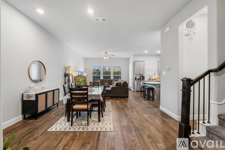 A dining room with a wooden table and chairs.