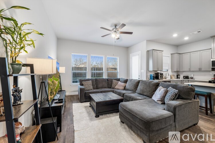 A living room with a grey couch and a coffee table.