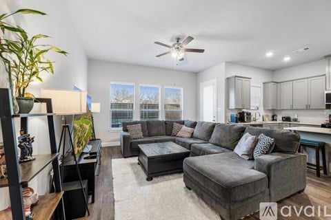 A living room with a grey couch and a coffee table.