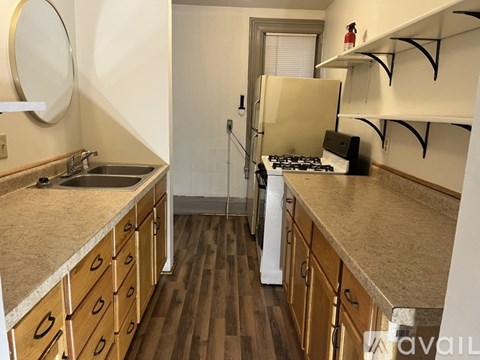 A kitchen with wooden cabinets and a white refrigerator.