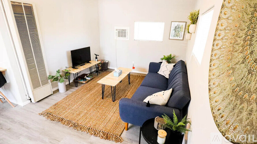 A living room with a blue couch and a television.