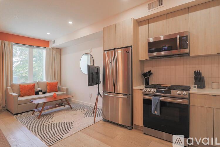 A kitchen with a refrigerator, oven, and microwave.