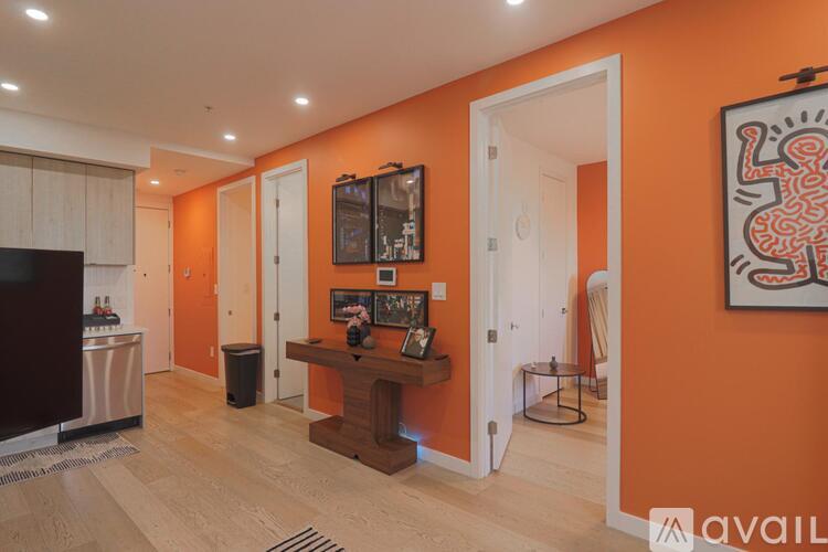A living room with orange walls and a television.