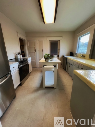 A kitchen with a table and chairs in the middle of the room.