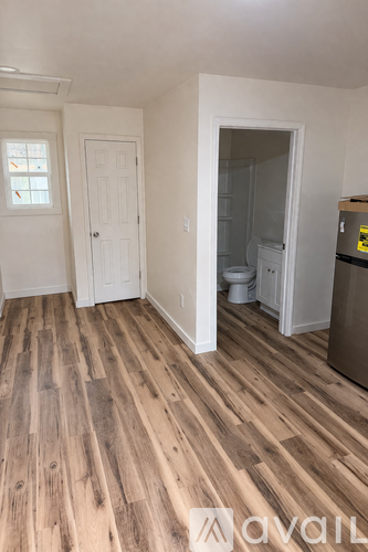 A room with wooden floors and white walls.