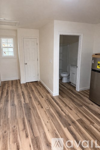 A room with wooden floors and white walls.