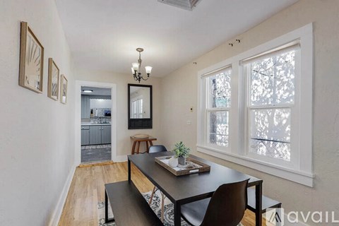 A dining room with a table and chairs.