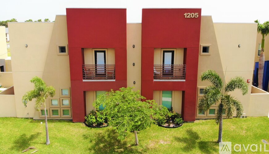 A red and beige building with the number 1205 on it.