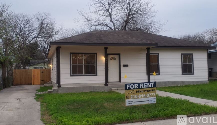 A house with a "For Rent" sign in front of it.
