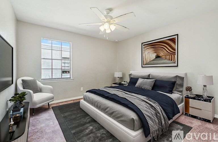 A bedroom with a bed, nightstand, and chair.
