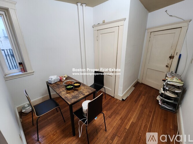 A dining area with a table and chairs in a room.