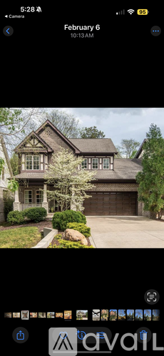 A house with a large front yard and a driveway.