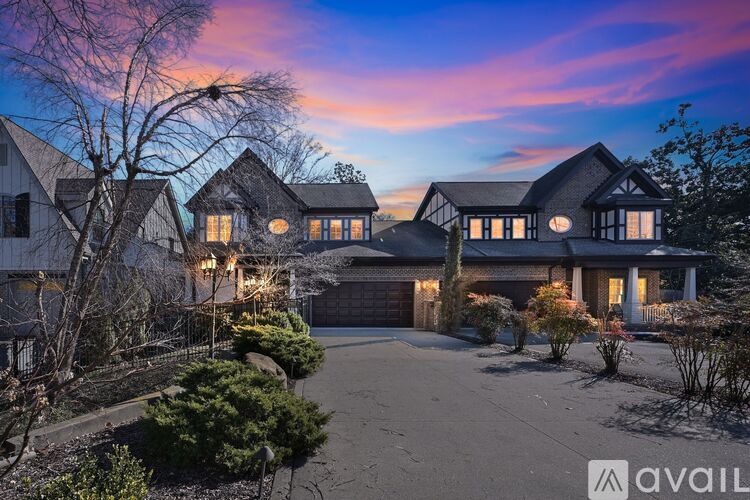 A large house with a driveway in front of it.