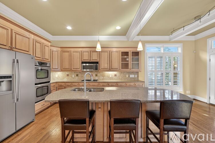 A kitchen with wooden cabinets and a granite countertop.