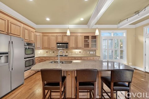 A kitchen with wooden cabinets and a granite countertop.