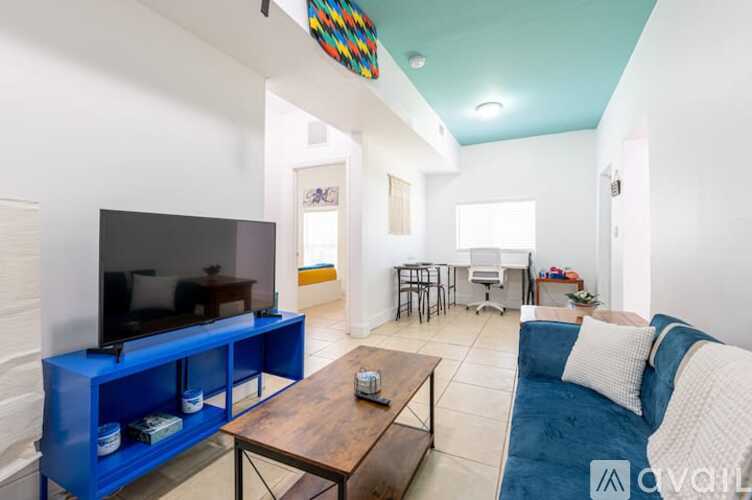 A living room with a blue couch and a television.